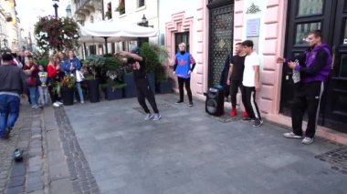 Lviv, Ukrayna - 15 Eylül 2019: Bilinmeyen adamlar şehrin sokaklarında dans molası veriyor. Yavaş çekim.
