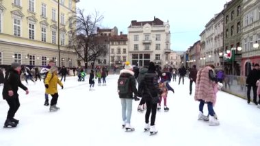 LVIV, UKRAINE - DECEMBER 15, 2019:  Unknown people skate in the square of the city.