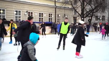 LVIV, UKRAINE - DECEMBER 15, 2019:  Unknown people skate in the square of the city.