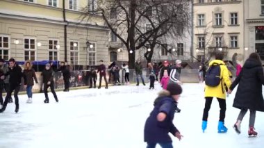 LVIV, UKRAINE - DECEMBER 15, 2019:  Unknown people skate in the square of the city.