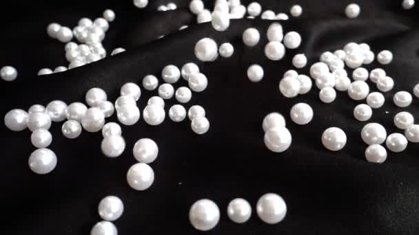 White Pearls Fall Black Fabric Slow Motion — Stock Video