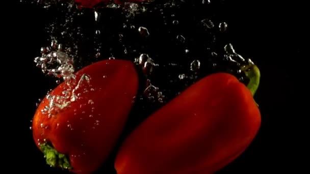Falling Sweet Pepper Slow Motion Black Background — Stock Video