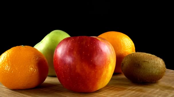 Kiwi Apples Oranges Black Background Cutting Board Movement — Stock Video