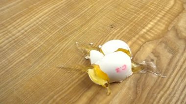 Yumurta tahtaya düşer ve kırılır. Yavaş çekim.