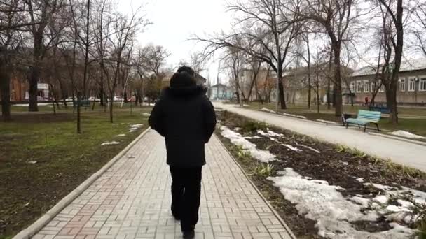 男は通りに沿って行く 公園での銃撃戦 — ストック動画