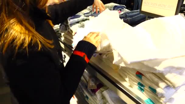 Торгівля Магазинах Європи Дівчинка Вибирає Одяг Продаж Знижки — стокове відео