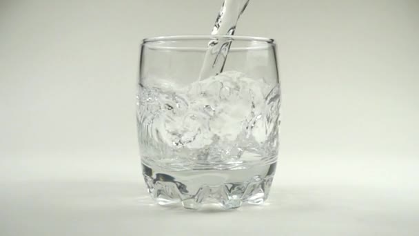 Water is poured in a glass. Slow motion. 480 fps. Slow motion.