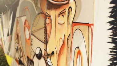 Sanatçı çitlere grafiti çiziyor. Çitin üzerindeki graffiti.