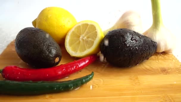 Lemon Avocado Chilli Pepper Garlic Water Splashes Slow Motion — Stock Video