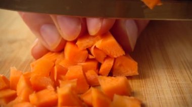 Aşçı bir bıçakla havuç keser. Yavaş çekim.
