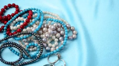 İncilerden boncuklar. Mavi ipek üzerinde çekim