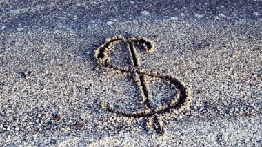 Kumdaki dolar işareti. Kum ve para birimi.