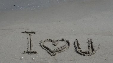 Seni seviyorum, kumdaki bir yazı. Sahilde çekim yapmak..
