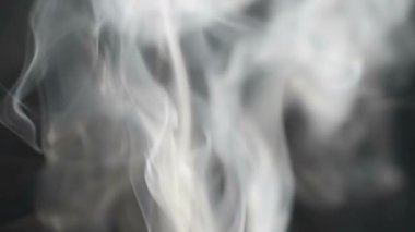 Ağır çekim. Siyah arka planda gri duman. Duman ve arkaplan