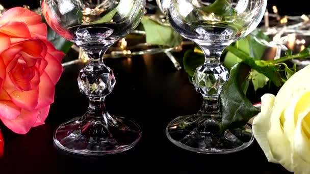 ワイングラスと明るいガーランドの背景にバラ — ストック動画