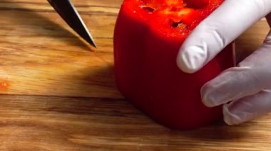 Tahta kesme tahtasında tatlı biber dilimliyorum..