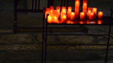 Kırmızı ve sarı saydam avizelerde kilise mumları.