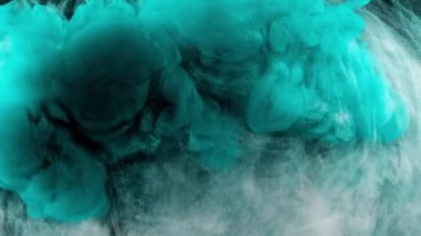 Soyut formlar. Siyah arka planda çekim yapmak. Boyaların karıştırılması.