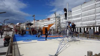 LA CORUNA, SPAIN - APRIL 2, 2018: Children at the playground on the city embankment. La Coruna the large city in the northwest of Spain, the resort and the port.