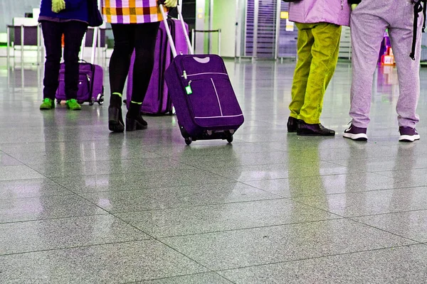 passengers to the airport with suitcases register on the plane