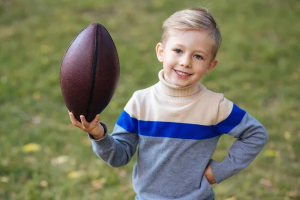 smiling boy with ball in the park