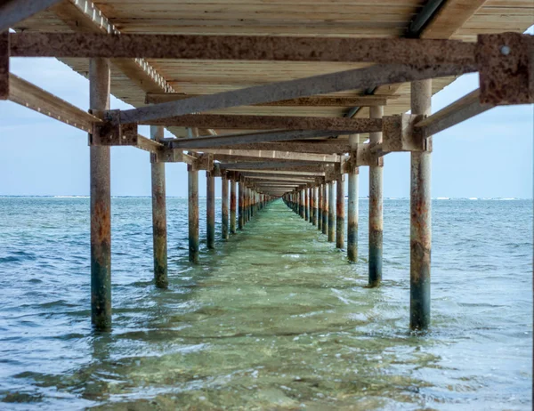 Under old rusty pier — Stock Photo, Image