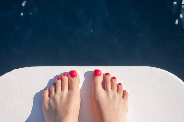 wooman feet on white yacht bow