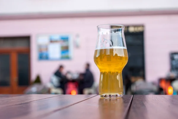 glass of beer on table edge