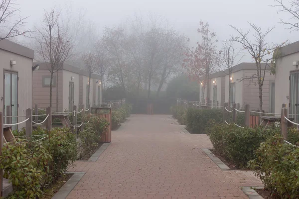 foggy street among camp houses