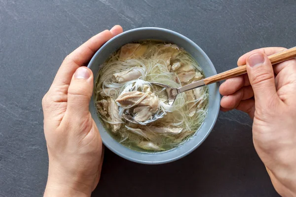 Asian soup with duck man hands — Stock Photo, Image