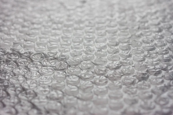 Bubbelplast förpackning på svart och grå bakgrund — Stockfoto