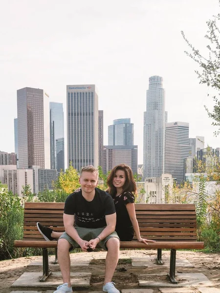 Young Couple Blond Man Brunette Girl Dress Sitting Chatting Bench — Stock Photo, Image