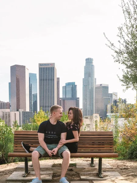 Young Couple Blond Man Brunette Girl Dress Sitting Chatting Bench — Stock Photo, Image