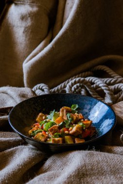 Sebzeli kızarmış tavuk çuval bezinin üstünde.