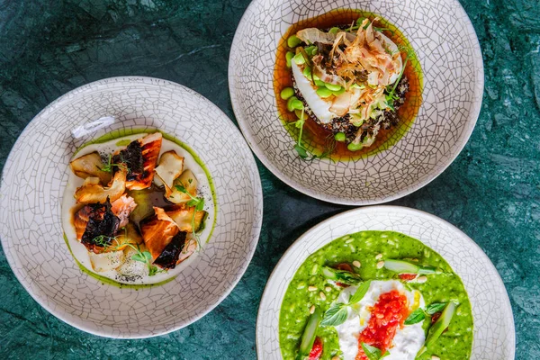 Koyu yüzeydeki tabaklarda servis edilen gurme çeşitliliğinin üst görünümü