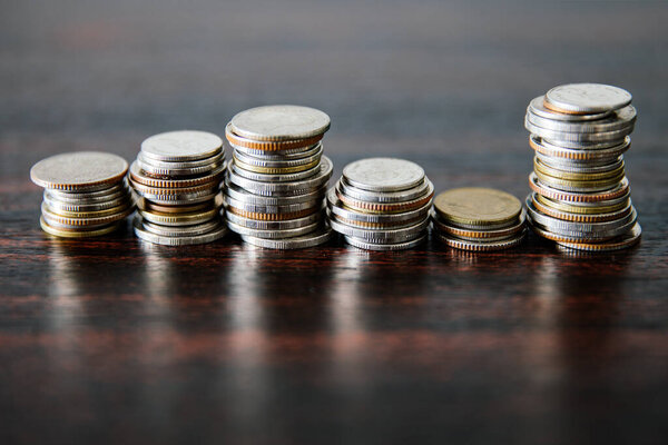 Stack of coins on wooden table, money, financial, business concept