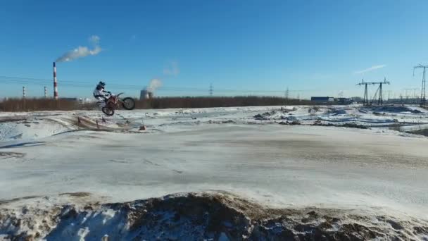 オートバイの運転手が冬のコースでスタントを行い — ストック動画
