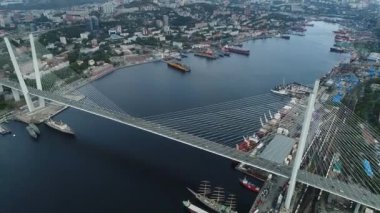 a big , white cable-stayed bridge,close-up,aerial wiev. the port of Vladivostok