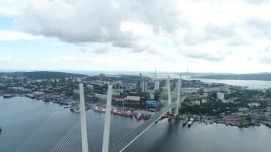 a big , white cable-stayed bridge,close-up,aerial wiev. the port of Vladivostok
