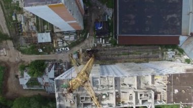 İnşaat işçileri tarlada bir apartman inşa ediyorlar, hava manzaralı.