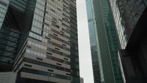 Torre del centro de negocios en el cielo desvanecido fondo, disparado desde abajo hacia arriba — Vídeo de stock