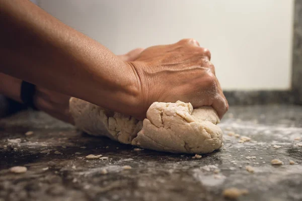 Hands making bread doe. A POV shot