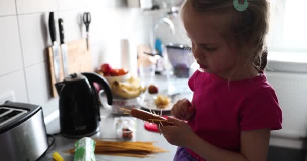 Little blond Girl in pink Cooking and Play in the kitchen — Stock Video