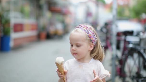 Pequena menina bonita gosta de comer sorvete — Vídeo de Stock