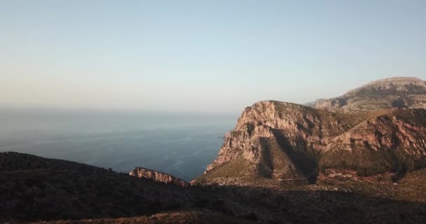 Rocky ocean shore against the blue cloudless sky from a birds-eye view — Stock Video