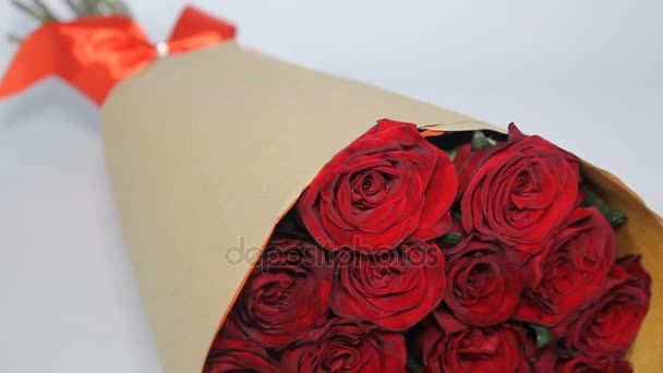 Red roses bouquet in paper package. static
