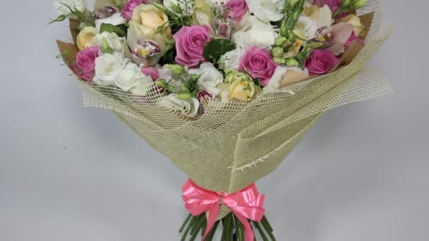 Pink roses and eustoma bouquet with bow. bottom to top motion