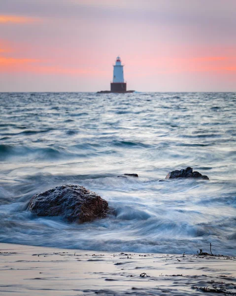 Felsiger Leuchtturm an der Küste bei Sonnenuntergang — Stockfoto
