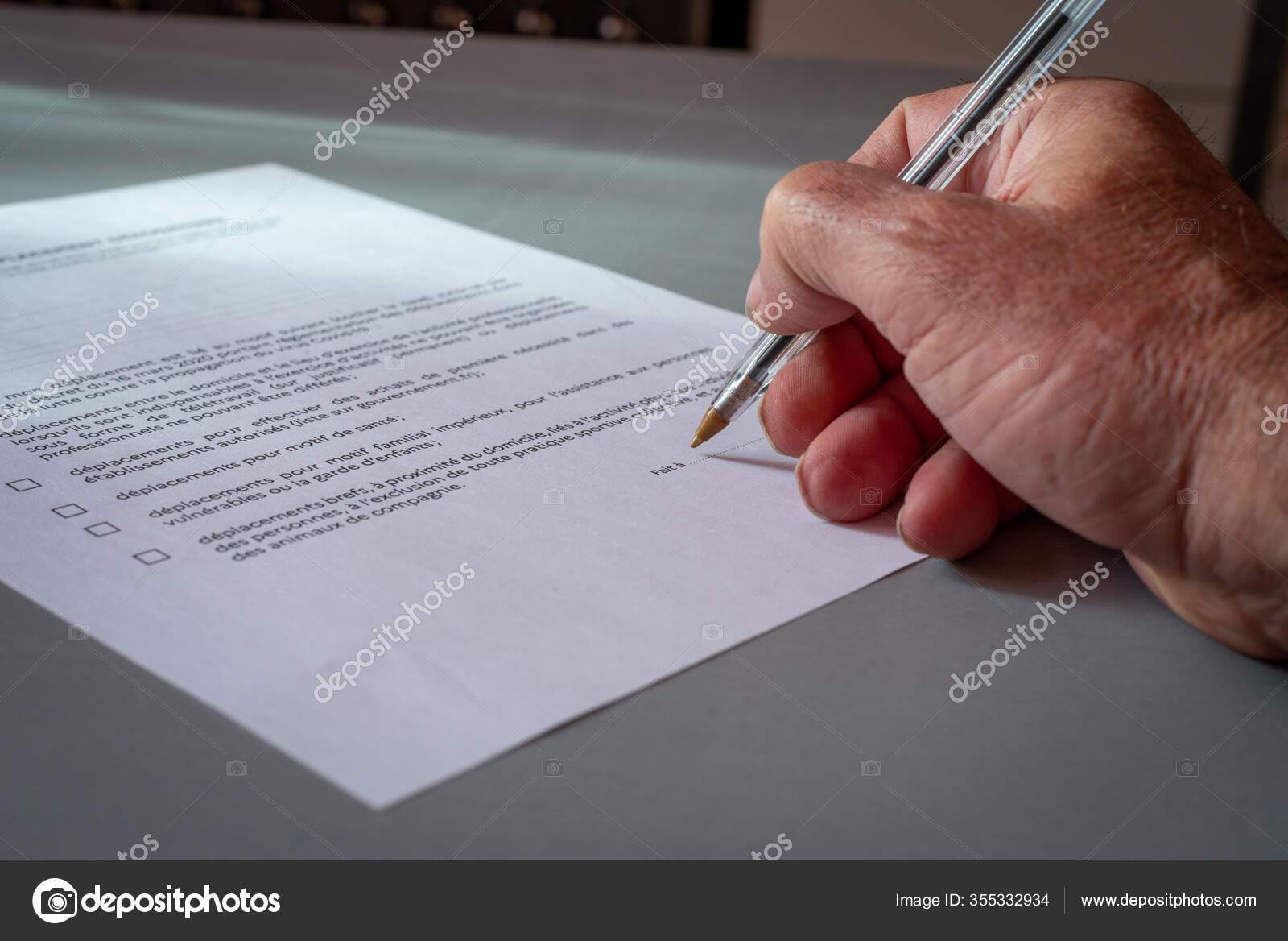 Close up of a Man signing french authorization to go out side, concept quarantine in France. 8 Close up of a Man signing french authorization to go out side, concept quarantine in France. 8