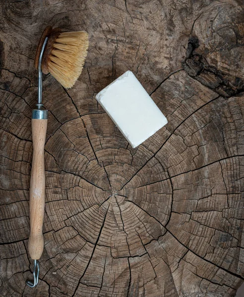 wooden  scubbing or dish brush and soap on wood table. concept zero  waste.;